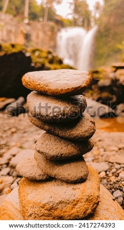 Rock Stack View with Waterfall Background