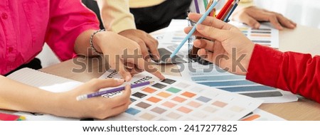 Creative interior designer brainstorming about color of material. Group of architect designer choose color carefully by using color swatches. Creative design and teamwork concept. Variegated.