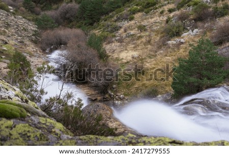San Mames waterfall in the mountains of Guadarrama in the middle of nature on an autumn day. Long exposure photography. Wild nature. Enjoying nature as a way of life. Madrid. Spain