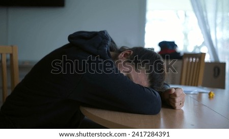 Desperate and Depressed Woman Sitting at Home, Feeling Overwhelmed and Burned Out Amidst Challenges Royalty-Free Stock Photo #2417284391