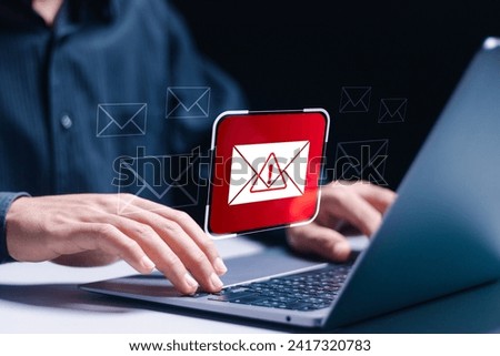 Person use laptop displays Email spam icon, junk, and e-marketing. Receive alerts for Email spam viruses. Caution, Internet letter security protection. Enhance online security.