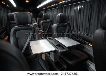 comfortable passenger bus interior with upholstered seats; individual transfer for a group of people; conversion of the interior of a truck; Royalty-Free Stock Photo #2417326351