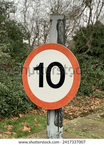 10 mile per hour sign on a pole