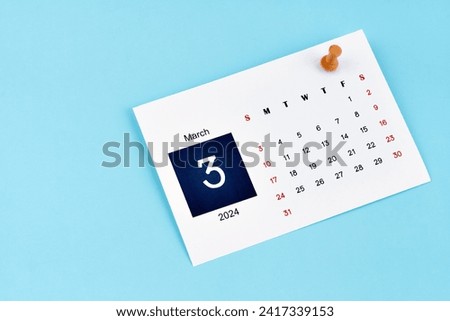 March 2024 calendar page with push pin on blue color background.