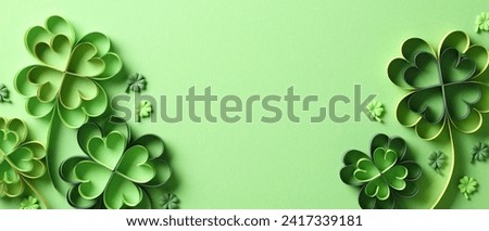 St Patricks Day banner design. Flat lay paper art four-leaf clover on green background with copy space. Royalty-Free Stock Photo #2417339181