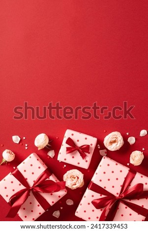 Valentine Day vertical banner with gifts decorated red ribbon bows, roses buds on red background. Flat lay, top view.