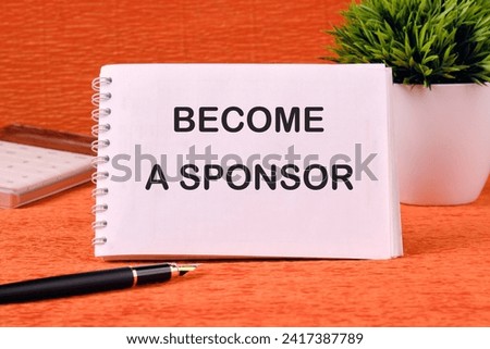 BECOME A SPONSOR text written on a blank sheet of notepad, there is a calculator, a pen and a flower in the background Royalty-Free Stock Photo #2417387789