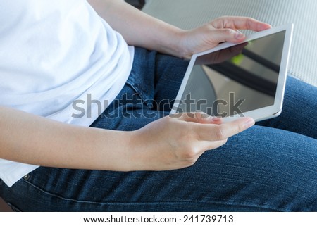 Woman hand hold white tablet with blank empty screen