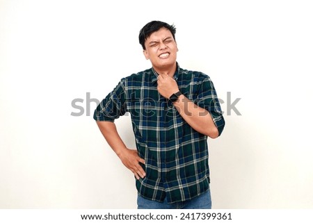 Young adult indonesian man suffering from sore throat. Isolated on white background Royalty-Free Stock Photo #2417399361