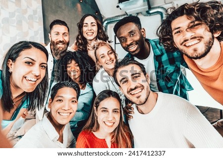 Multiracial friends taking group selfie shot at camera - Happy young people smiling together at smart mobile phone device at home - University students having fun together in college campus
