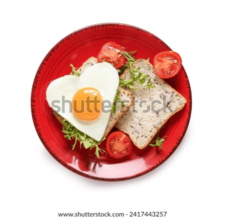 Plate with tasty fried egg, toasts, tomatoes and arugula on white background
