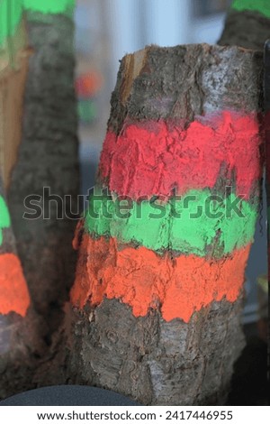 The branches of the tree are painted with bright colors.Drawing conventional marks on the tree with colored paint.