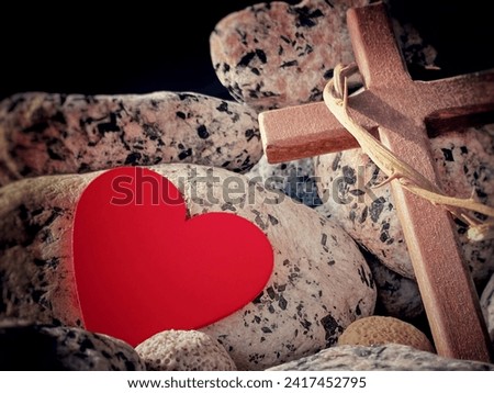 Lent, Holy Week, Good Friday, Easter Sunday Concept - Crown of thorn on wooden cross with red heart shape and stone background. Stock photo.