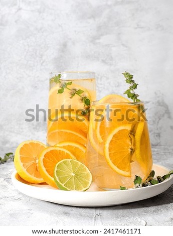 Concept of detox diet and body cleansing. Refreshing homemade lemonade cocktail with fresh lemon, lime, orange and mint. Fruit juice and ingredients, weight loss concept, healthy and natural food,