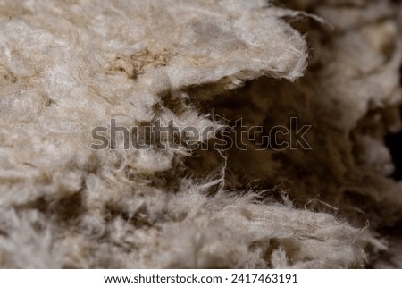 Close up of fibers of thermal insulation material, rock wool. Thermal roof insulation layer. Mineral wool or mineral fiber, mineral cotton, mineral fibre, glass wool Royalty-Free Stock Photo #2417463191