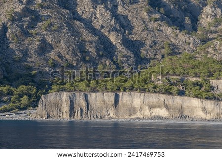 A picture of the Domata Beach cliffs and the surrounding landscape and coast.