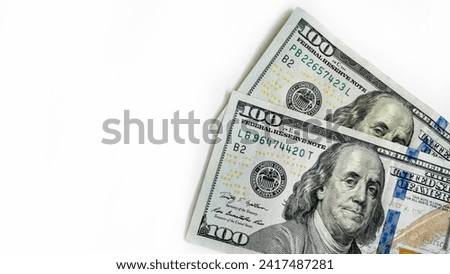 Two $100 bills. US dollars: 200 dollars. American money. Isolated on white horizontal background. Royalty-Free Stock Photo #2417487281