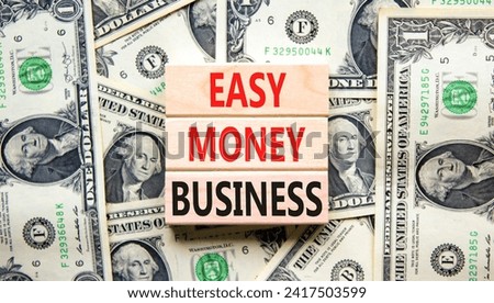 Easy money business symbol. Concept words Easy money business on beautiful wooden blocks. Dollar bills. Beautiful dollar bills background. Easy money business concept. Copy space.