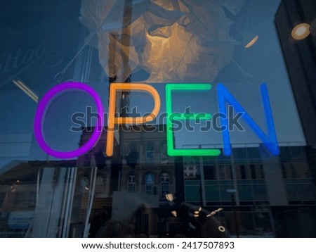 Neon open signage in a business storefront downtown Ottawa Ontario Canada.