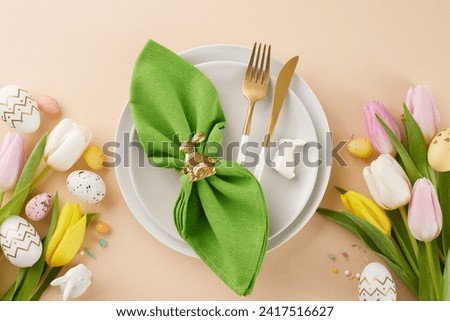 Crafting joy: a festive easter table creation. Top view photo of plates, cutlery, green napkin, eggs, tulips, ceramic bunnies, sprinkles on beige background