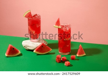 Color background for advertising drinks product with two glass cup of watermelon juice displayed. Front view and copy space. Watermelon is a good source of antioxidants and nutrients