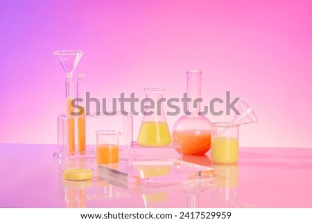 Yellow and orange liquid filled inside several laboratory glassware. Glass podium with empty space featured. Minimal scene with podium and abstract background