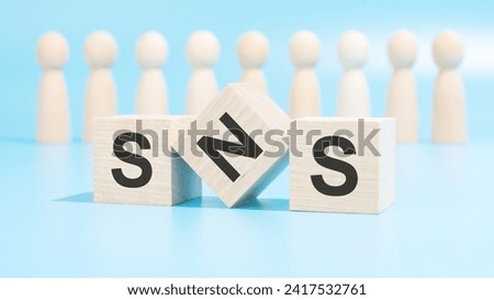 wooden blocks spell SNS, emphasizing the importance of optimizing social media. figures represent collaborative efforts. it conveys the need for effective strategies to enhance social media presence