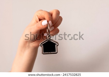 Female hand holding  home key 