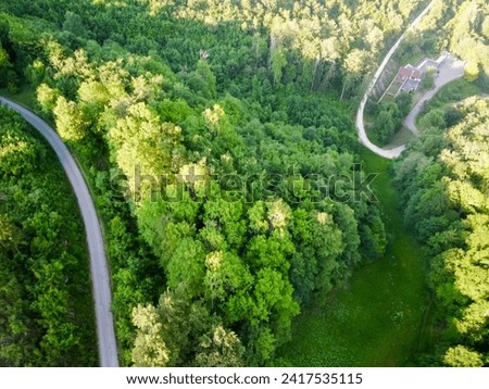  Aerial drone landscape photo of national park. Picture of green forest and road inside the forest and park. Popular travel destination for tourism in Europe. High quality photo