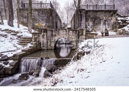 The Canal Locks at Side Cut Park in Maumee Ohio flow despite the cold wintery weather and snow surrounding.