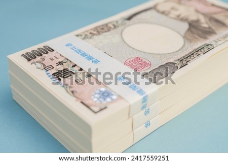 Piles of 10 thousand yen bills, 3 million yen, Japanese money or currency, Blue background