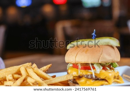 A close-up shot capturing a hamburger accompanied by a side of fries.