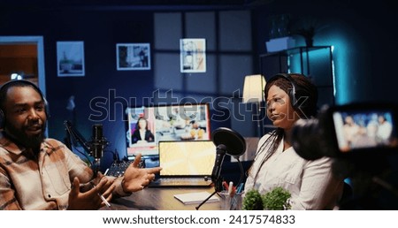African american influencers in studio using high tech camera for internet show production on livestreaming channel. Vloggers partners doing podcasting session with professional video gear