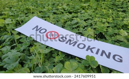 No smoking sign on green grass, No tobacco banner