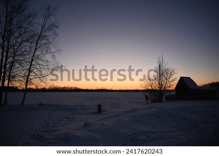 Alaska landscape and buildings with full moon.