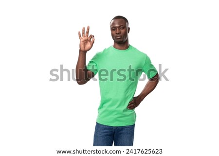 young confident american man dressed in green t-shirt with textile print mockup