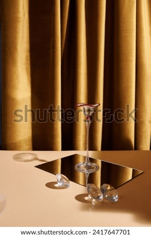Elegant studio shots featuring a glass centerpiece, warm mustard-beige tones, and captivating light-shadow play