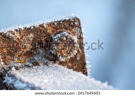 The rusty metal, covered with frost, froze. Royalty-Free Stock Photo #2417649603