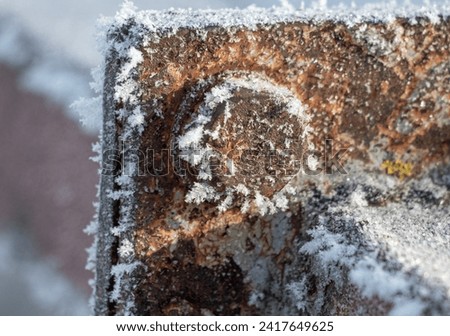 The rusty metal, covered with frost, froze. Royalty-Free Stock Photo #2417649625