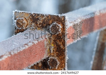 The rusty metal, covered with frost, froze. Royalty-Free Stock Photo #2417649627