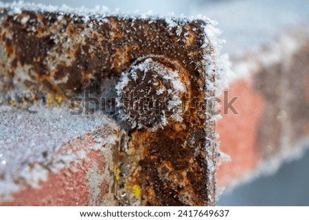 The rusty metal, covered with frost, froze. Royalty-Free Stock Photo #2417649637