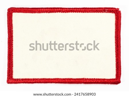 White rectangular patch with red trim. Royalty-Free Stock Photo #2417658903