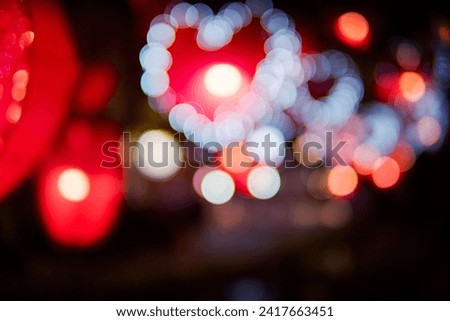 City night light blur bokeh , defocused red heart light background.