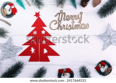 Christmas concept composition decoration objects, fir tree branch wreath and ornament isolated on white wooden table, top view, flat lay, layout up.
