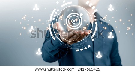 Target Achievement and Business Goals Digital Concept : Business professional presenting a target and goal achievement concept with digital holographic projection. Royalty-Free Stock Photo #2417665425