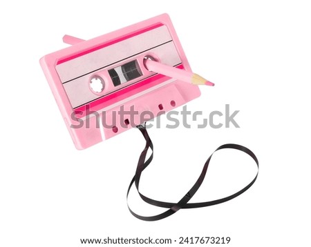 Cassette tape with pencil isolated on white background