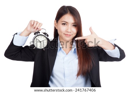 Young Asian businesswoman point to alarm clock  isolated on white background