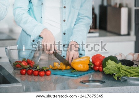 cropped image woman cutting vegetables