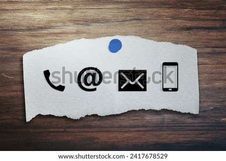 CONTACT US Icons on post it on wood table. Concept of business or customer service.