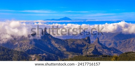 Grand Canary island, panoramic view of Roque nublo over clouds and view of Theide volcano in Tenerife. Canaries islands of Spain Royalty-Free Stock Photo #2417716157